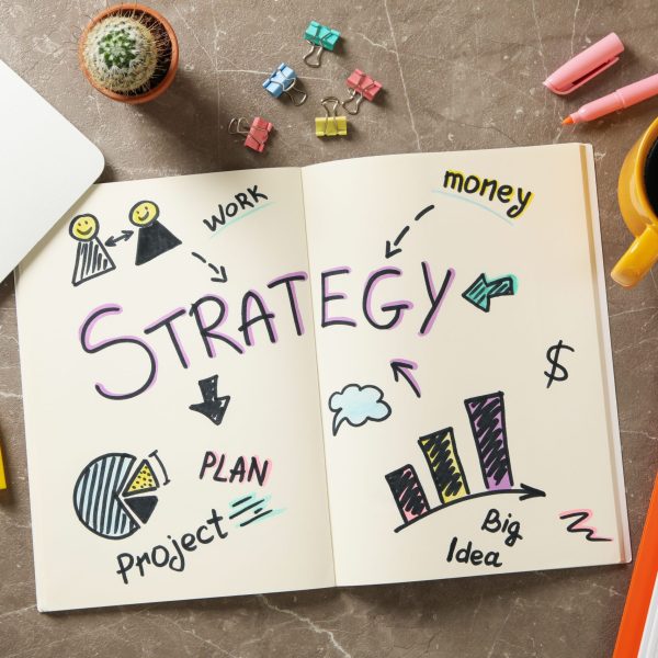 Concept of business strategy on gray table, top view