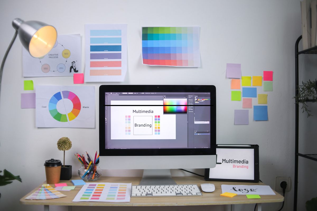 Brand design system displayed across multiple digital screens for consistent multimedia branding