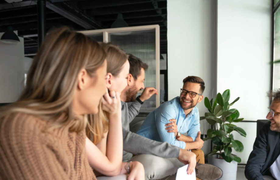 Colleagues engaging in a lively group discussion representing a highly engaged brand community