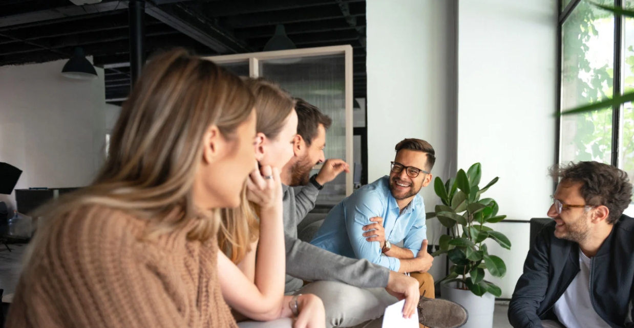 Colleagues engaging in a lively group discussion representing a highly engaged brand community