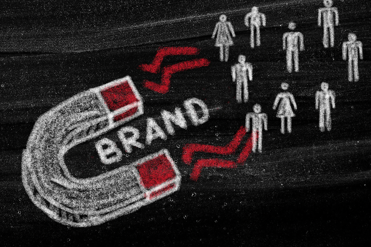 Chalkboard drawing of a magnet pulling audience figures toward a central brand concept.